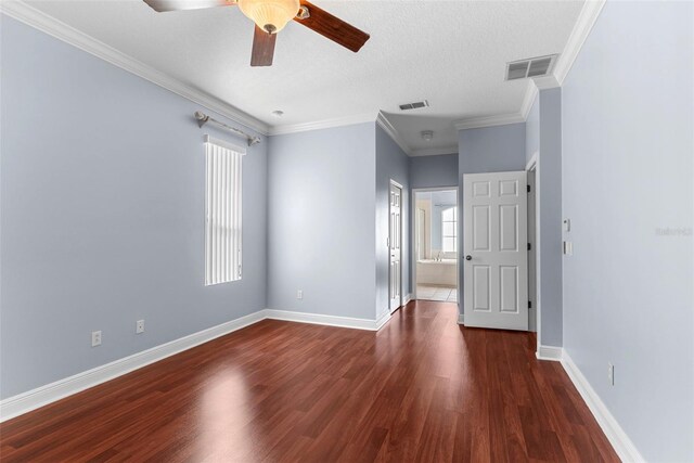 spare room featuring a textured ceiling, crown molding, dark hardwood / wood-style floors, and ceiling fan