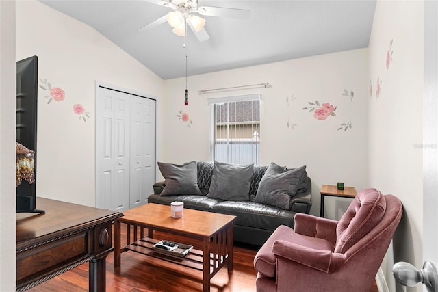 living room featuring ceiling fan, hardwood / wood-style floors, and lofted ceiling