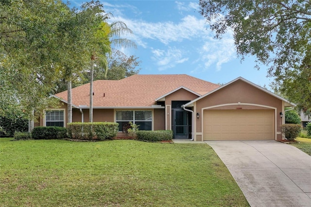 single story home featuring a garage and a front yard