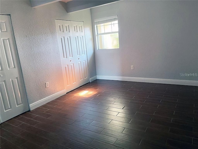 unfurnished bedroom with dark hardwood / wood-style floors