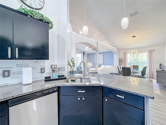 kitchen with ceiling fan, tasteful backsplash, dishwasher, vaulted ceiling, and sink