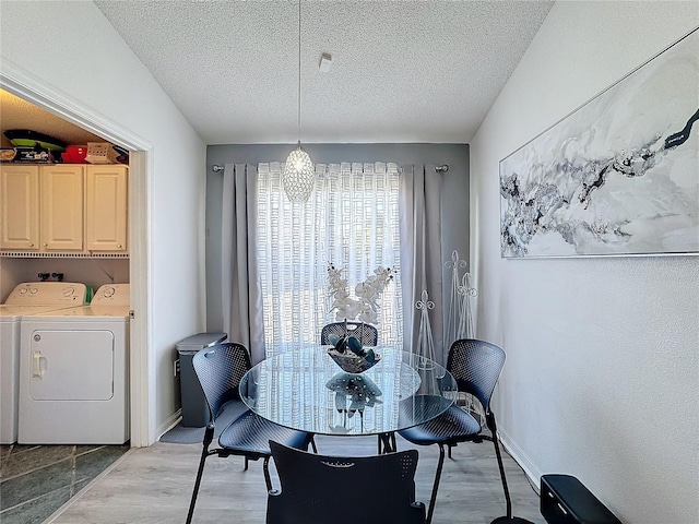 dining area featuring washer and dryer and a textured ceiling