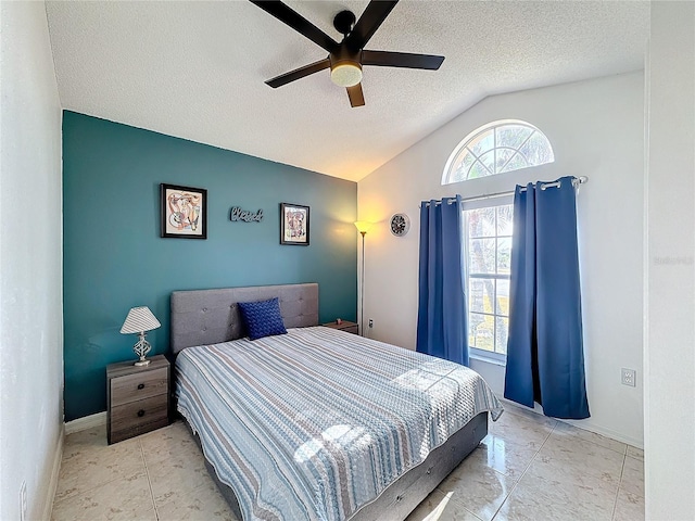 bedroom featuring ceiling fan, a textured ceiling, and vaulted ceiling