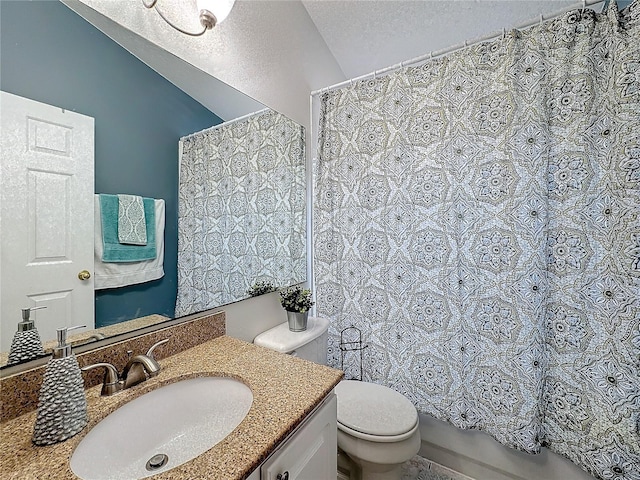 bathroom featuring a textured ceiling, toilet, and vanity