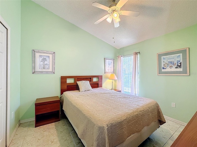 bedroom featuring ceiling fan, a textured ceiling, light tile patterned floors, and vaulted ceiling