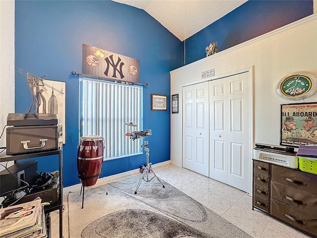 misc room featuring light tile patterned floors and lofted ceiling