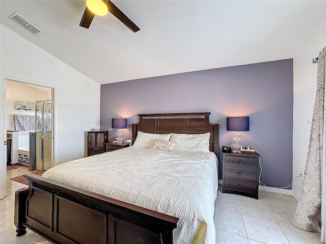 bedroom with ceiling fan, ensuite bath, vaulted ceiling, and light tile patterned flooring