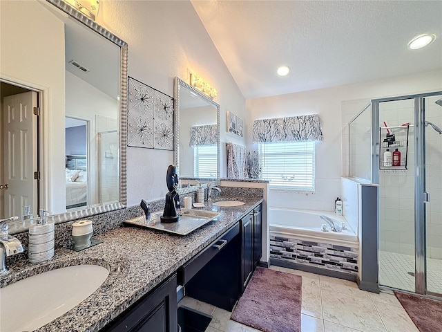 bathroom with a textured ceiling, tile patterned floors, vanity, vaulted ceiling, and independent shower and bath