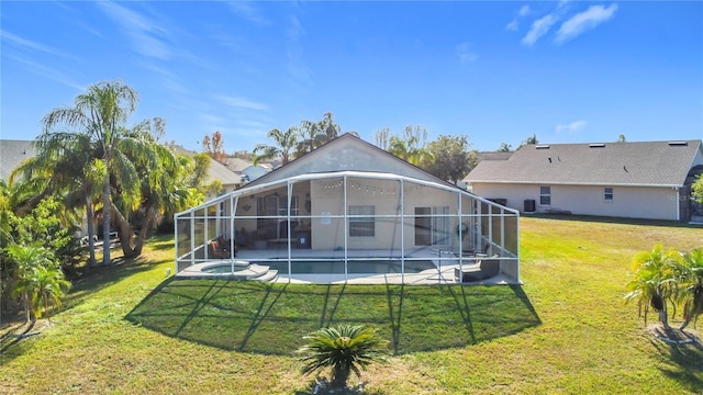 back of house with glass enclosure, a lawn, and a patio