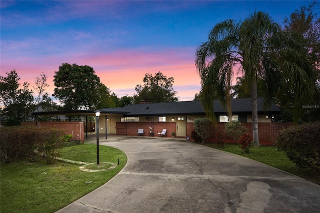 single story home with a carport and a lawn