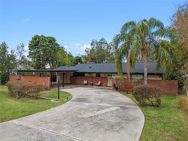 ranch-style home featuring a front yard and a carport