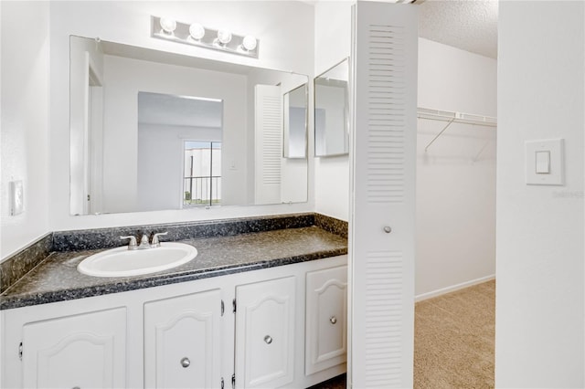 bathroom featuring vanity and a textured ceiling