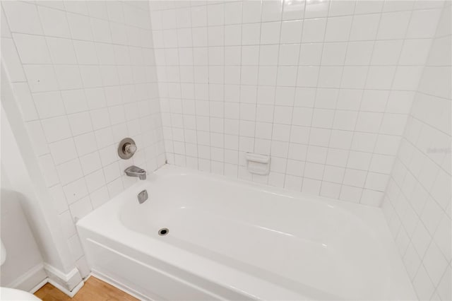 bathroom featuring wood-type flooring and shower / tub combination