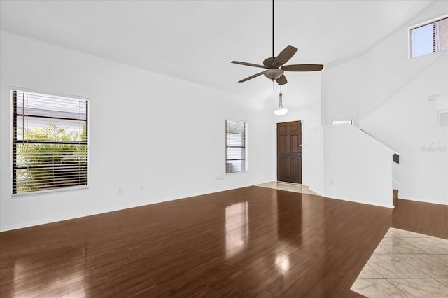 unfurnished living room with wood-type flooring and vaulted ceiling