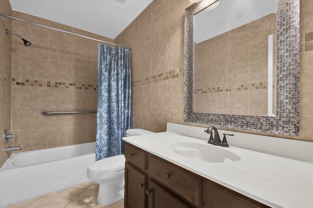 full bathroom featuring toilet, tile walls, vanity, shower / bath combo, and tile patterned flooring