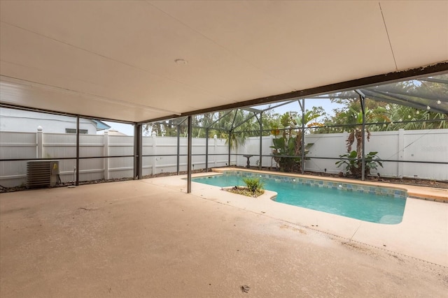 view of pool with a patio and glass enclosure