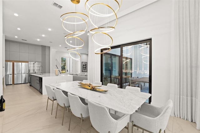 dining room with an inviting chandelier and sink