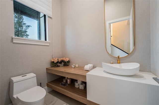 bathroom with toilet and vanity