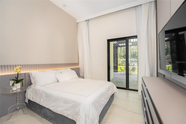 bedroom featuring lofted ceiling and access to outside