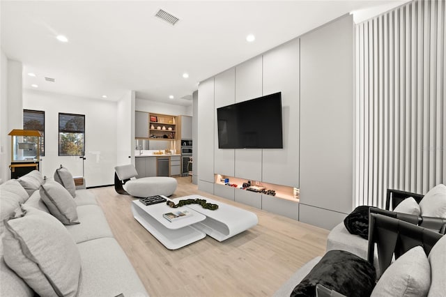 living room with light hardwood / wood-style flooring