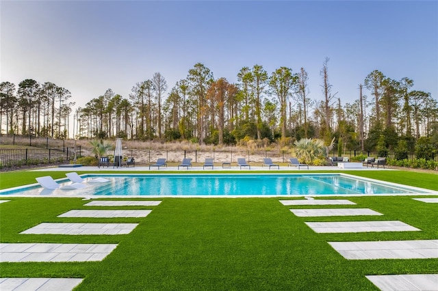 view of swimming pool featuring a patio area and a lawn