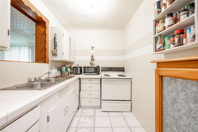 kitchen with light tile patterned flooring, white electric range oven, sink, decorative backsplash, and white cabinets