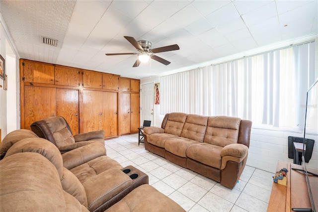 tiled living room featuring ceiling fan