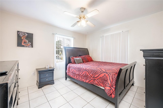 tiled bedroom featuring ceiling fan