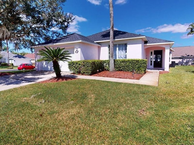 view of front of property with a garage and a front lawn