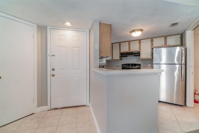 kitchen with stainless steel fridge, black range with electric stovetop, a textured ceiling, light tile patterned flooring, and kitchen peninsula