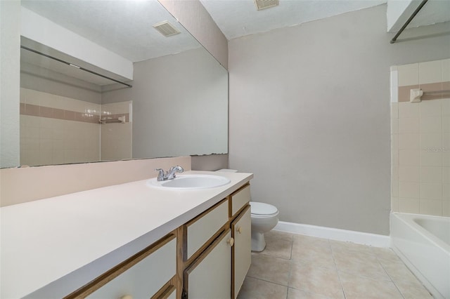 full bathroom featuring tile patterned floors, toilet, tiled shower / bath combo, and vanity