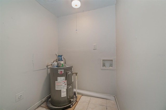 laundry area featuring electric dryer hookup, hookup for a washing machine, electric water heater, and light tile patterned flooring