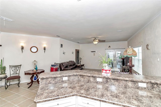 kitchen featuring ceiling fan, light tile patterned floors, light stone countertops, white cabinets, and french doors