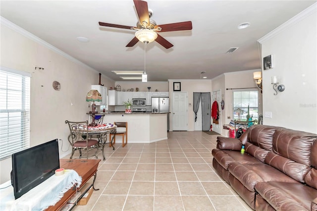 tiled living room featuring ceiling fan and ornamental molding