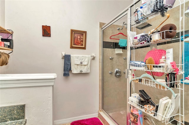 bathroom featuring a shower with door