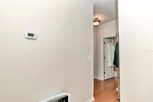hallway with hardwood / wood-style flooring