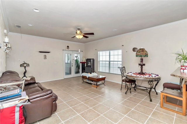 tiled living room featuring ceiling fan, crown molding, and french doors