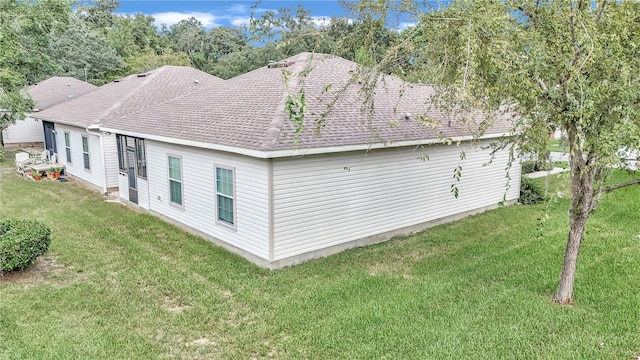 rear view of house featuring a yard