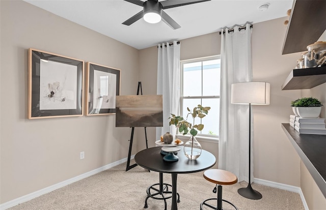 interior space featuring ceiling fan, light carpet, and a healthy amount of sunlight