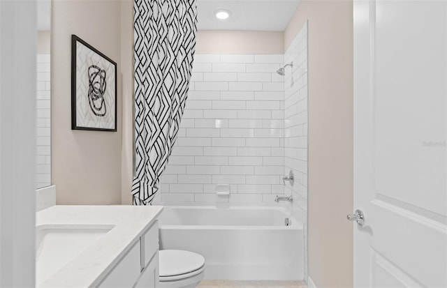 full bathroom featuring toilet, vanity, and tiled shower / bath combo