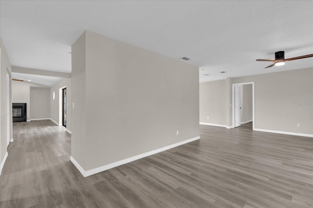 spare room with ceiling fan and wood-type flooring