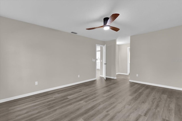 spare room with ceiling fan and dark hardwood / wood-style flooring