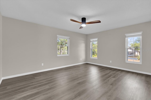 spare room featuring ceiling fan and dark wood-type flooring