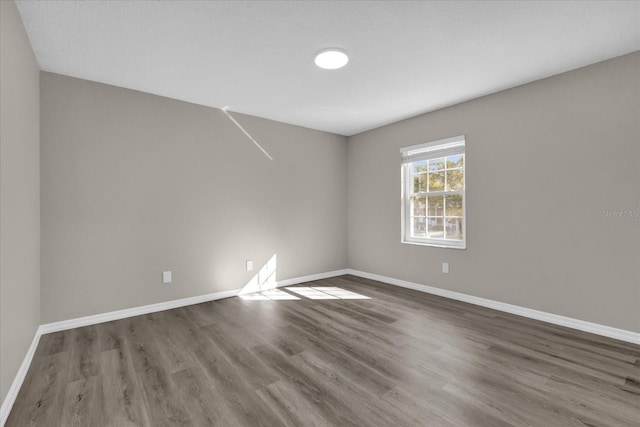 spare room with wood-type flooring