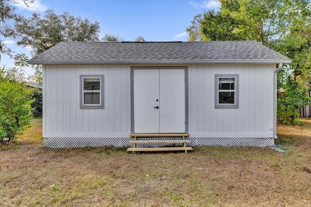 view of outbuilding with a yard