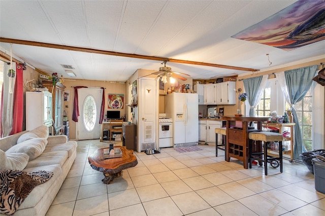 living room with ceiling fan and light tile patterned floors