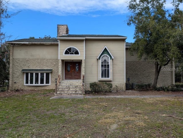 view of front of property with a front lawn and french doors