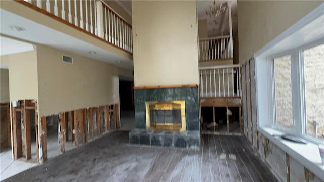 unfurnished living room featuring a tiled fireplace