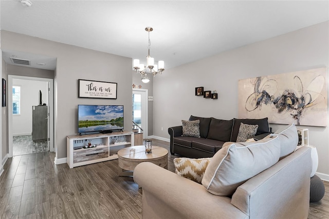 living room featuring hardwood / wood-style flooring and a notable chandelier