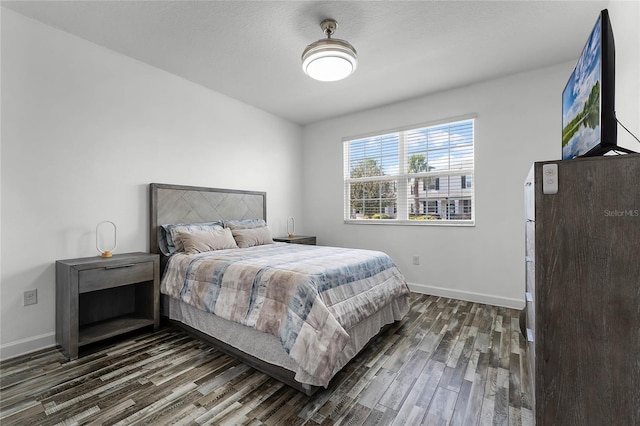 bedroom with dark hardwood / wood-style flooring